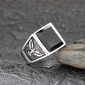 Macro detail of men's vintage eagle wing ring with rectangular black onyx stone inlay