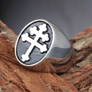 Macro shot of vintage titanium steel ring with black oval plate and white double cross detail