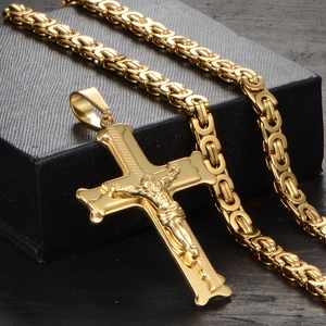 Detail of gold Jesus crucifix pendant with heavy Byzantine chain on black jewelry box
