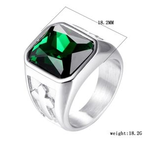 Detail view of emerald green stone ring with cross relief and 18.2mm width dimension