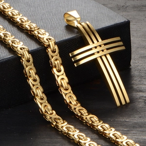 Detail view of gold Byzantine chain with a multi-layered architectural cross pendant