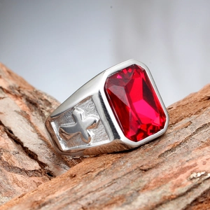 Macro detail of men's vintage cross ring featuring a large rectangular red gemstone