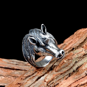 Vintage punk unicorn ring in stainless steel with retro silver finish shown on bark