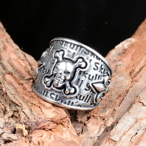 Gothic punk skull stainless steel ring for men on rustic bark background