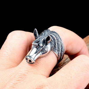 Macro shot of a punk unicorn ring in vintage stainless steel worn on a finger