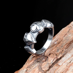 Punk style heart pattern titanium steel ring for men on rustic wood background