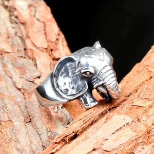 Retro stainless steel elephant ring with detailed engraving on natural wood surface