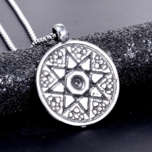 Detailed close-up of a silver stainless steel hexagram pendant on a sturdy box chain