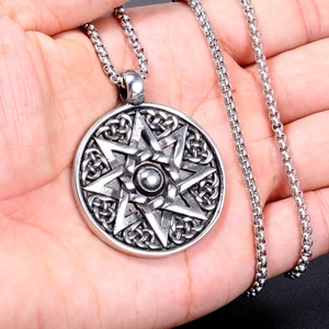 Detail of a stainless steel octagram necklace with a Celtic knot design on a box chain
