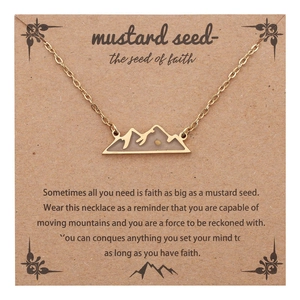 Golden mountain pendant necklace with mustard seed on a card, minimalist jewelry gift