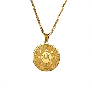 Macro detail of golden stainless steel Buddhist pendant with embossed sacred scriptures