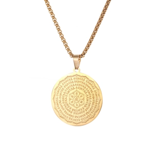 Detail view of golden stainless steel round pendant featuring engraved lotus and mantra