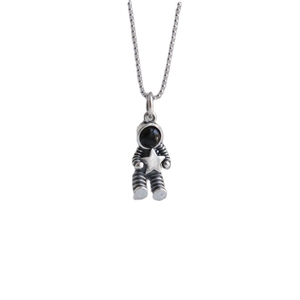 Minimalist astronaut holding a star pendant necklace with beaded chain on white background