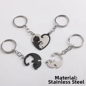 Close-up of stainless steel heart-shaped puzzle cat keychains for couples