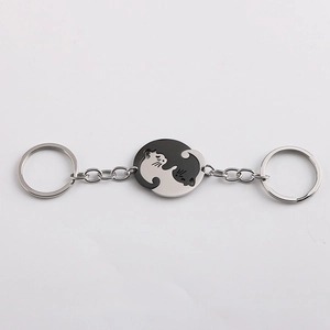 Detail view of heart-shaped black and silver cat yin yang stainless steel keychains