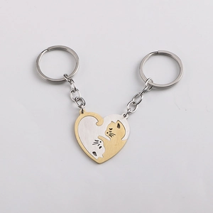 Detailed view of heart-shaped cat puzzle keychains in gold and silver brushed metal finish