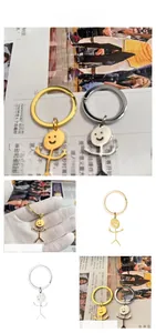 Detail view of funny stickman middle finger keychains in polished gold and silver finish