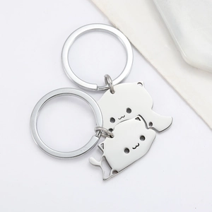 Polished stainless steel interlocking cat keychains for couples on a white background