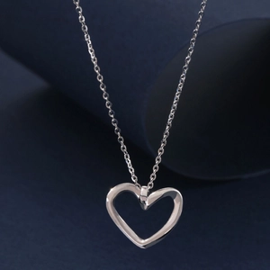 Minimalist S925 sterling silver hollow heart pendant necklace on dark background