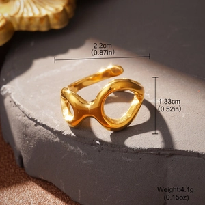 Detailed view of gold knotted ring on textured stone with dimensions 2.2cm by 1.33cm