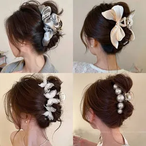 Detail showing four different large hair claw clips with pearls and silk ribbon styles