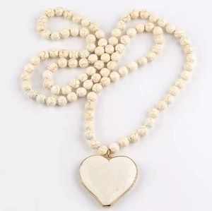 Handmade white turquoise beaded long necklace featuring a gold-edged heart pendant