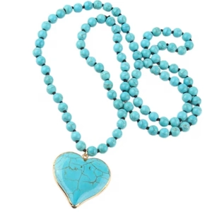 Bohemian turquoise beaded necklace featuring a large heart pendant with gold-plated edges