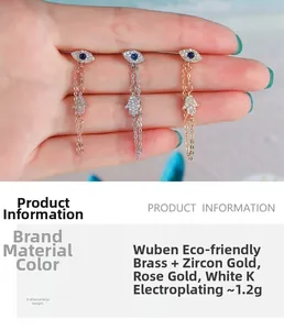 Detailed close-up of Hamsa hand and Evil Eye earrings in gold, rose gold and silver