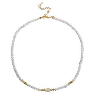Detail of marble beaded necklace featuring freshwater pearl and gold lobster clasp