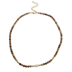 Detailed view of handmade beaded necklace with brown agate stones and baroque pearl charm