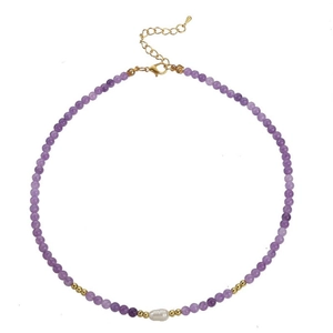 Detail of purple agate beaded necklace with central freshwater pearl and golden clasp