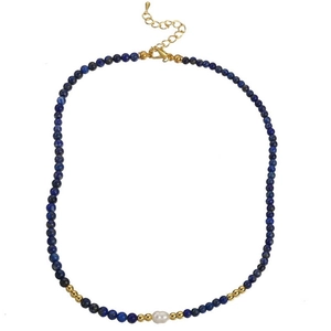Detail of beaded necklace featuring deep blue lapis lazuli beads and a freshwater pearl