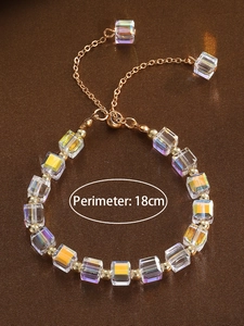 Detail of adjustable gold bracelet with colorful square crystals and sliding clasp