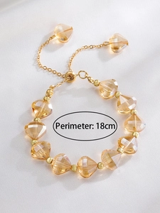 Detail view of adjustable gold bracelet with faceted champagne crystal beads and 18cm length
