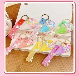 Colorful floating ice cream bottle keychains in six pastel colors on a wooden table