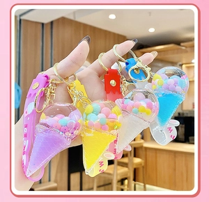 Detailed set of four ice cream float keychains with liquid quicksand and colorful beads