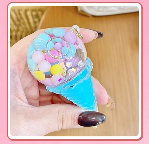 Detail of ice cream keychain with colorful macaron beads and stars inside transparent dome