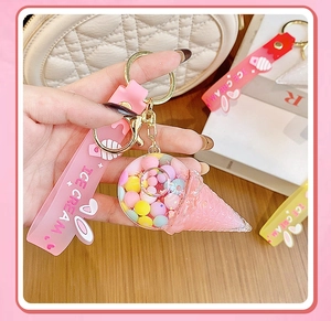 Detail of pink ice cream keychain with colorful floating beads and silicone wrist strap