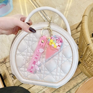 Cute colorful ice cream keychain with pink silicone strap on white handbag