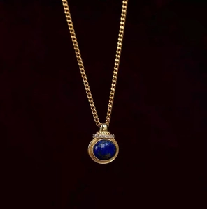Vintage gold necklace with round blue lapis lazuli pendant and sparkling crystals