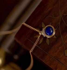 Vintage lapis lazuli pendant necklace in gold plating shown on an elegant wooden box