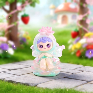 Detailed view of a pearlescent cartoon fairy figurine with floral headpiece for desk