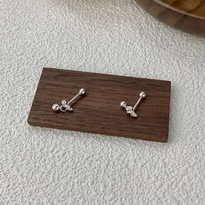 Elegant S925 sterling silver bow knot screw back earrings on a luxury wooden stand