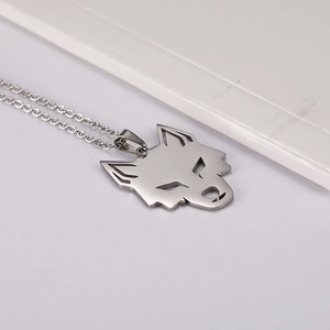 Détail macro du pendentif tête de loup géométrique en acier inoxydable poli argent