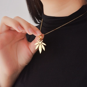 Elegant gold maple leaf pendant necklace on stainless steel chain for women