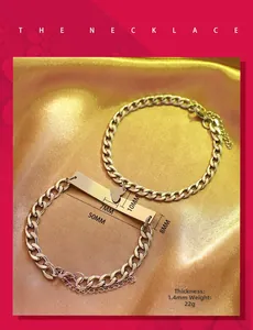 Macro detail of custom engraved heart and square plaque on stainless steel couple bracelet