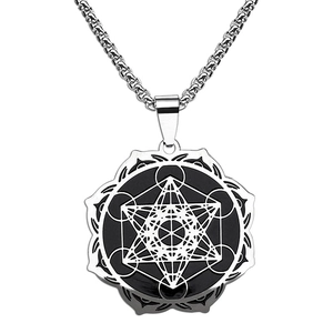 Macro detail of silver stainless steel pendant with Metatron's Cube engraving on round disc