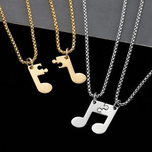 Collier couple puzzle avec notes de musique en acier inoxydable poli doré et argenté