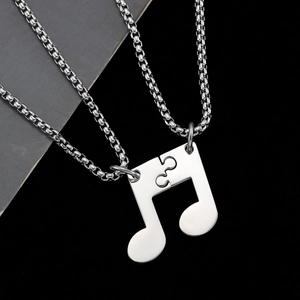 Colliers puzzle notes de musique en acier inoxydable poli pour couples sur fond noir