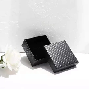 Elegant black diamond texture jewelry gift box for rings and earrings on a white floral background